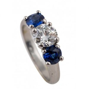 PLATINUM DIAMOND AND SAPPHIRE THREE-STONE ENGAGEMENT RING