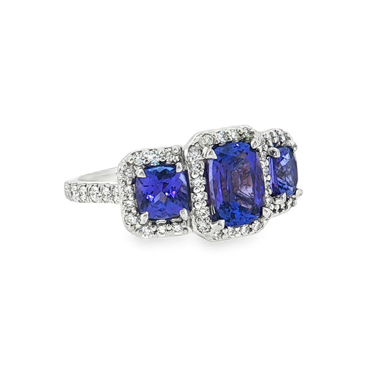 14kt white gold tanzanite and diamond three-stone halo ring