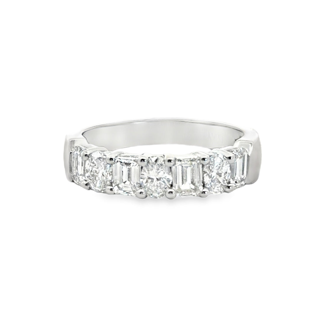 Platinum emerald and oval diamond part way band ring