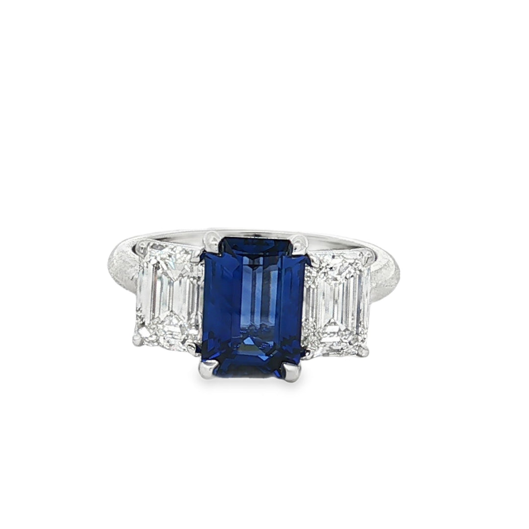 Platinum three-stone emerald-cut sapphire and diamonds ring
