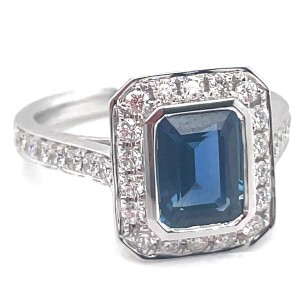 18kt White Gold Emerald Cut Sapphire And Diamond Halo Ring